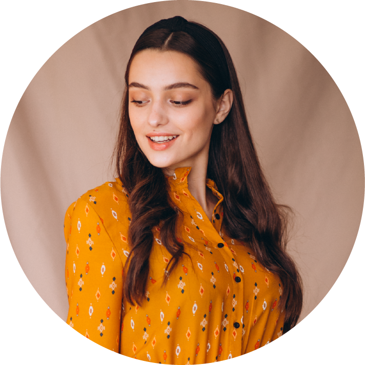 Woman wearing a yellow floral blouse against a beige background