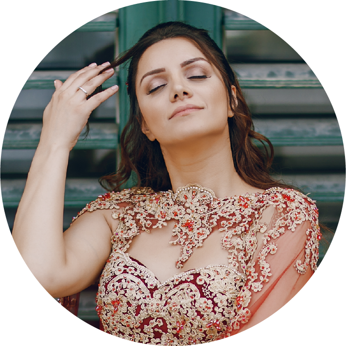 Woman wearing a intricately designed blouse with a blurred background