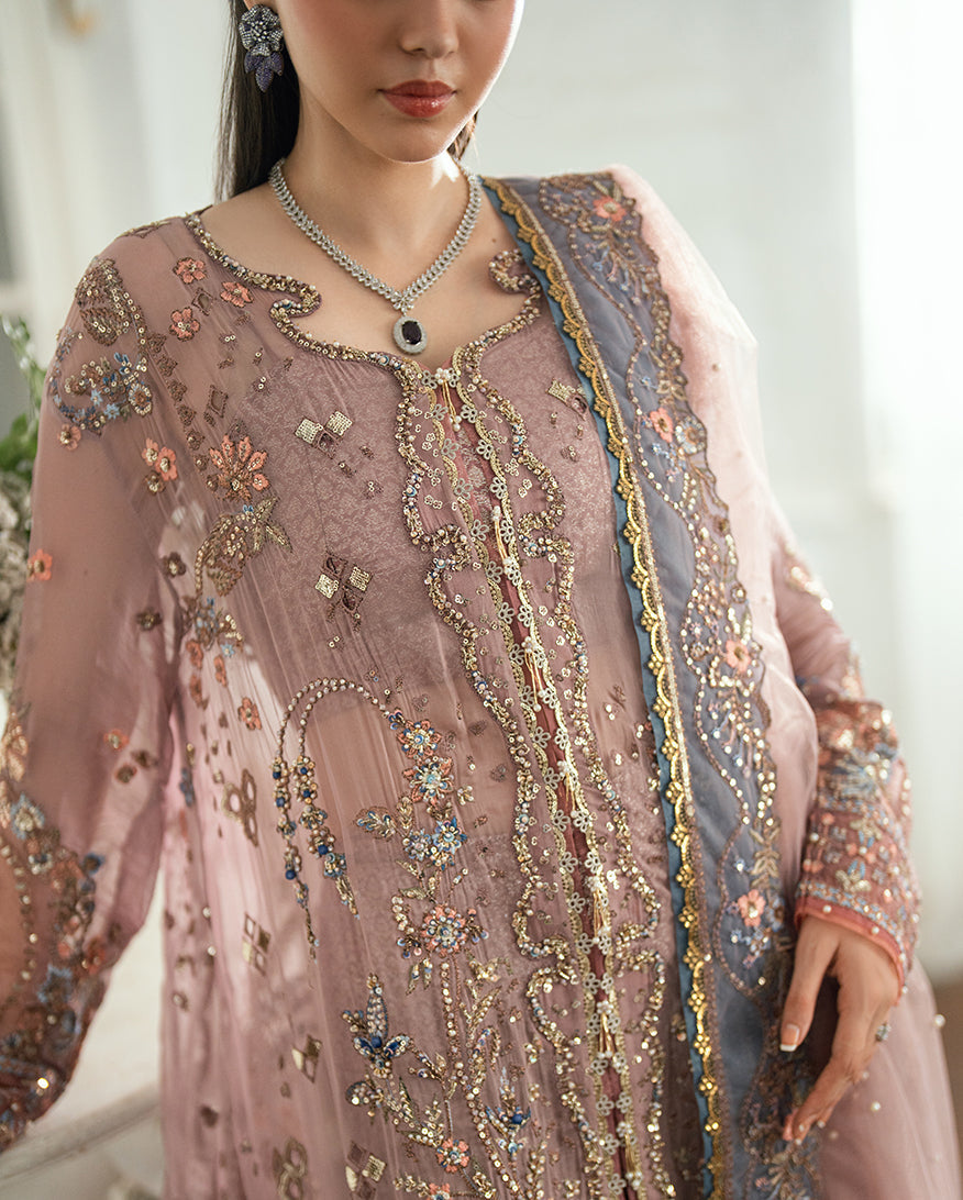 Close-up of the hand-embroidered neckline and upper bodice with floral and geometric sequin designs on the chiffon fabric