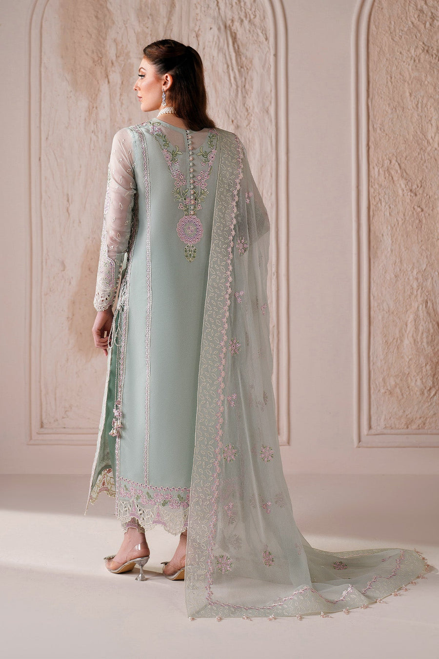 Back view of pastel green chiffon suit showing button details and embroidery