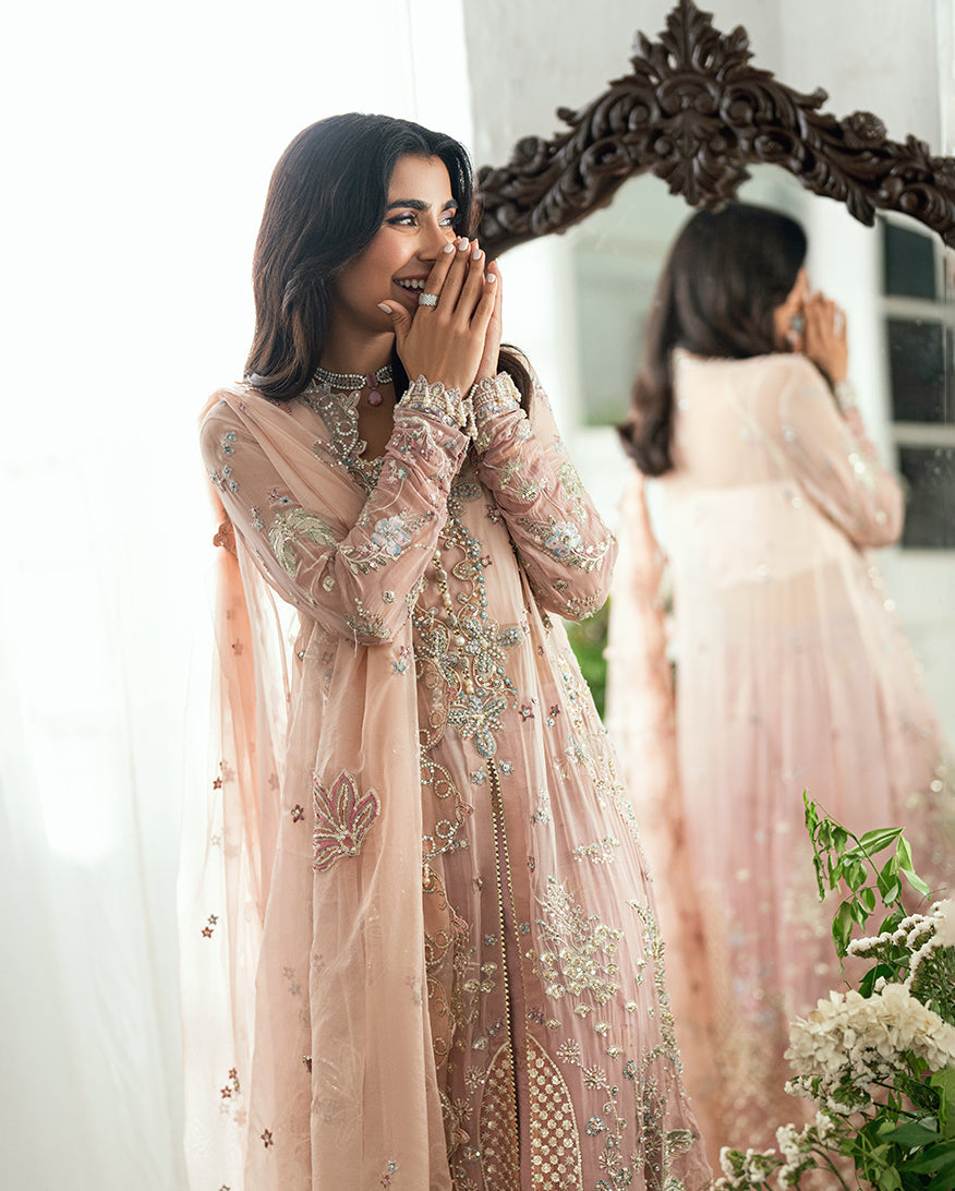 Close-up of woman's hands adorned with matching bangles complementing the detailed embroidery on sleeves of chiffon dress