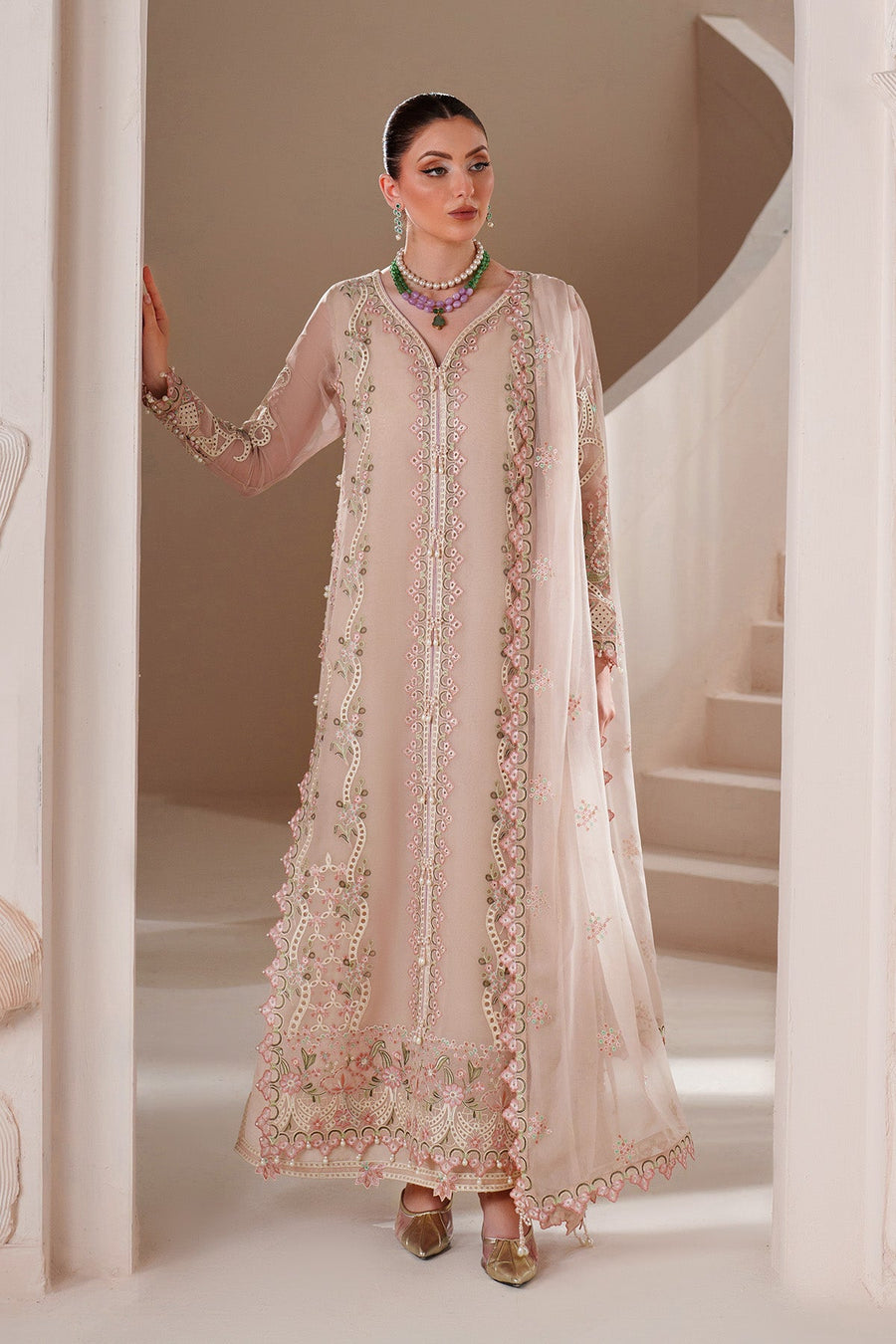 Full view of elegant beige chiffon dress with embroidered floral patterns worn by woman with matching dupatta