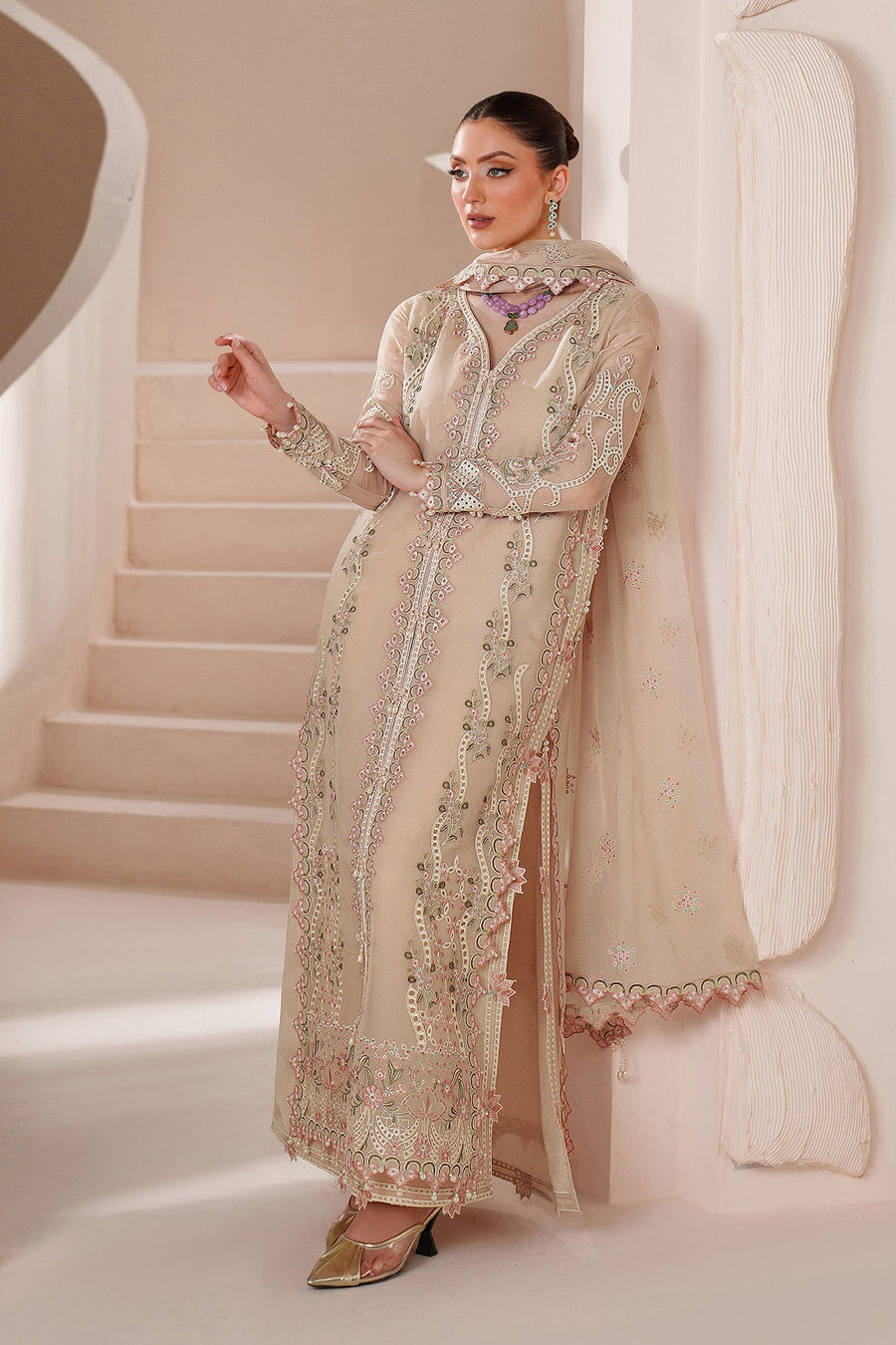Close-up capturing intricate embroidery and pearl beads on sleeve cuff of chiffon dress