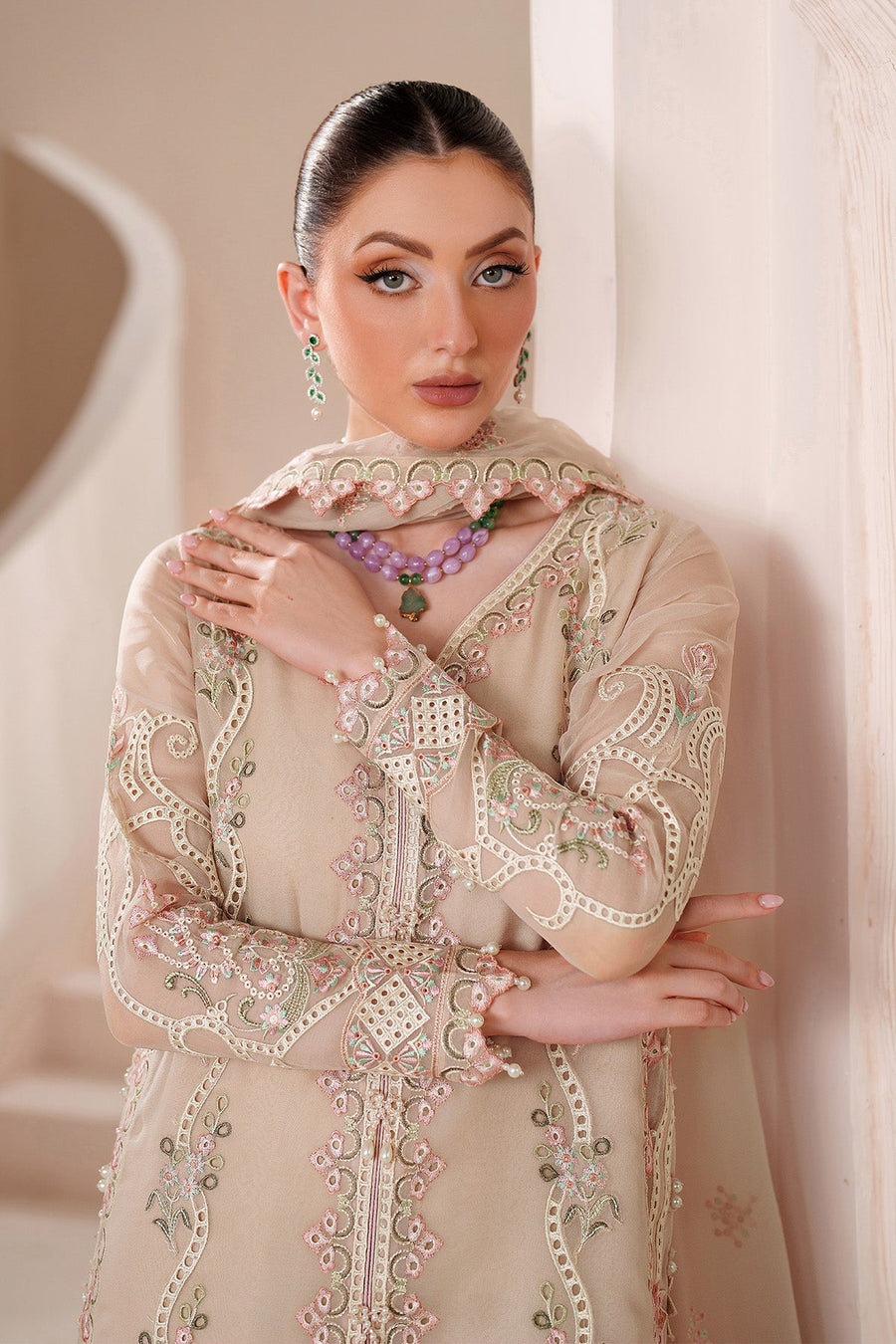 Elegant neckline embroidery framed with double layered beaded necklaces on woman wearing chiffon dress