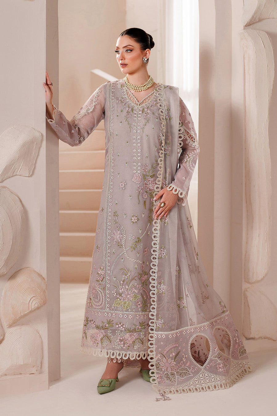 Woman wearing lavender chiffon embroidered formal suit with matching dupatta, posing indoors