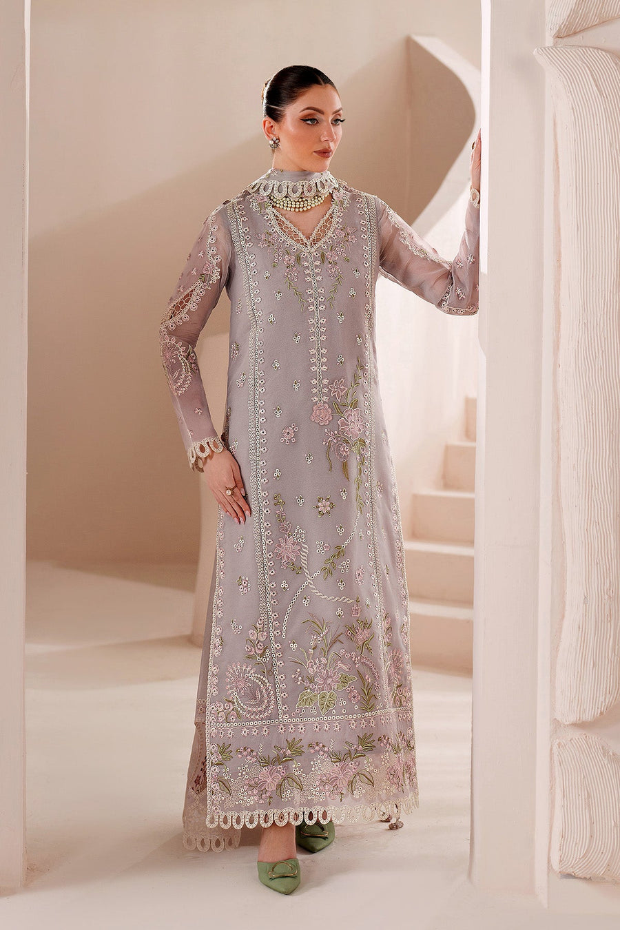 Model seated showcasing detailed embroidery and delicate lace trim on sleeves and dupatta