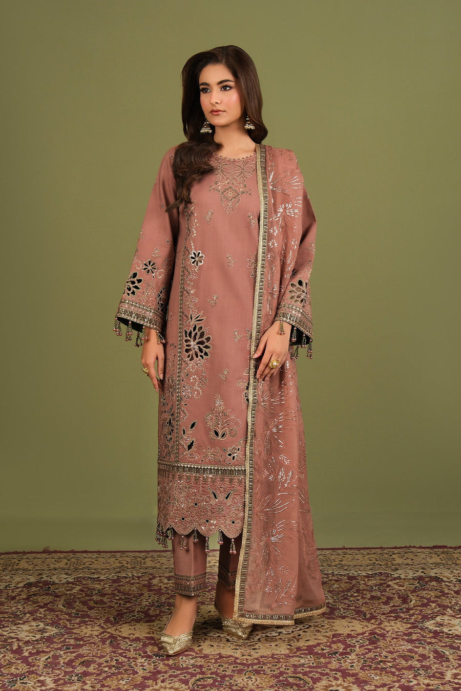 Close-up of shirt embroidery with bead tassel accents on sleeves