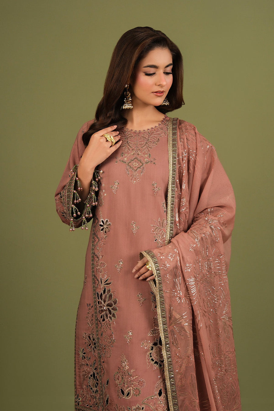 Side view of traditional embroidered suit with matching trousers