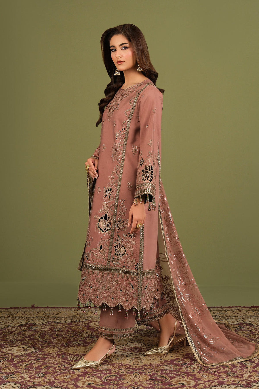 Close-up showing detailed floral embroidery and bead tassels on the outfit