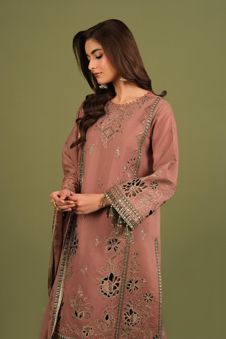 Model posing with embroidered long shirt and matching trousers
