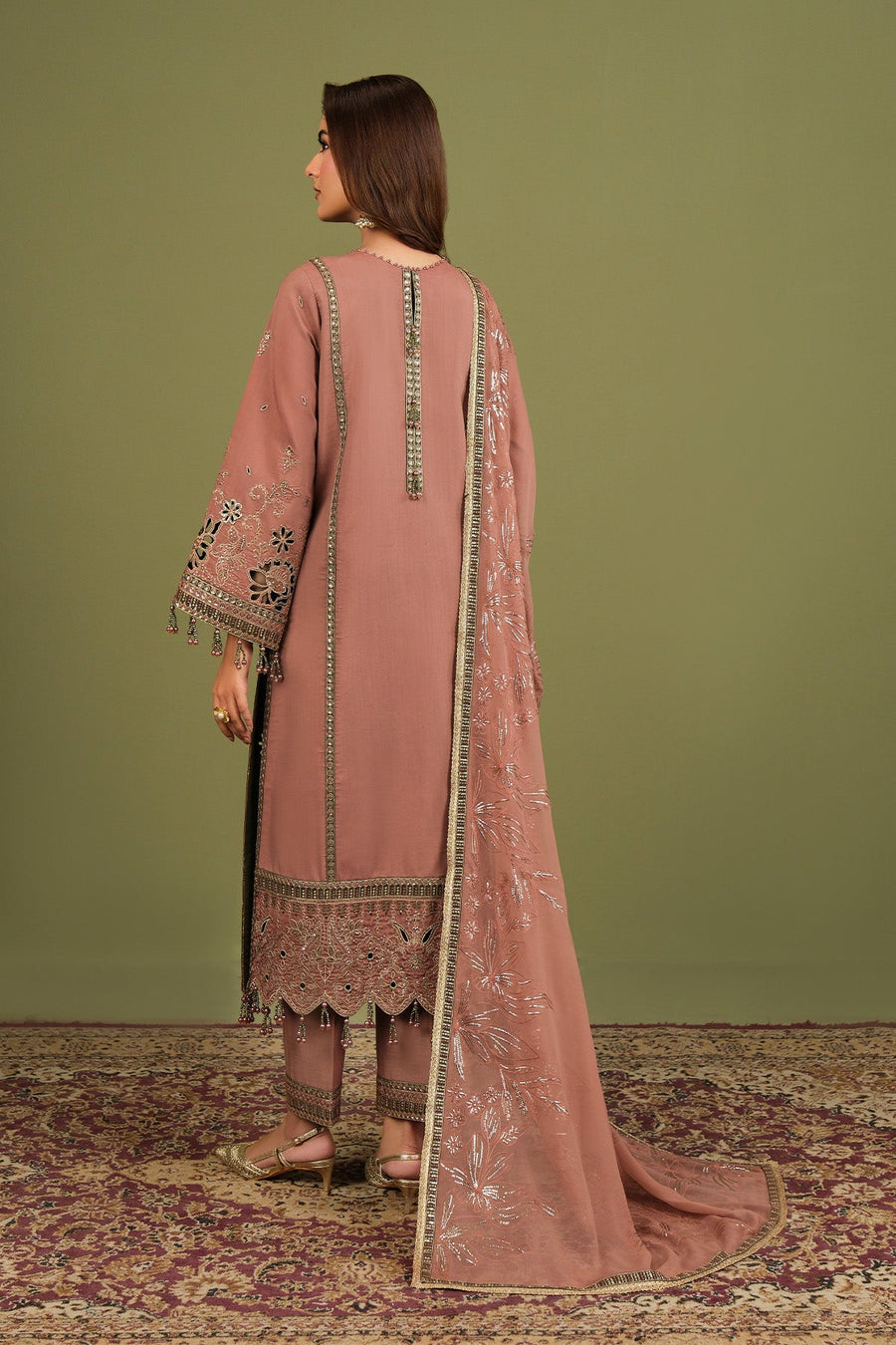 Back view showing full embroidery and detailing on the traditional suit