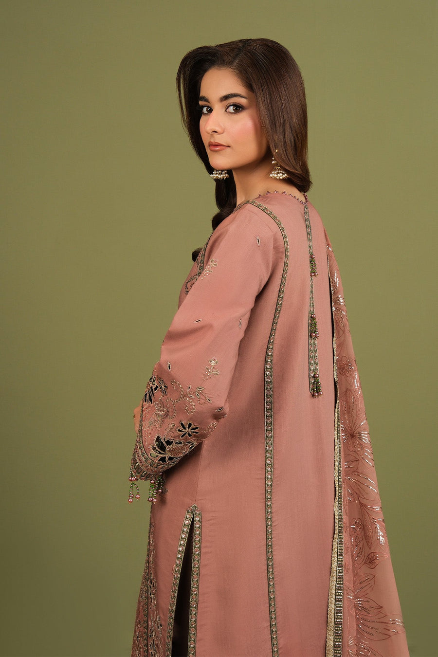 Detailed image of bead tassel embellishments on sleeve cuffs