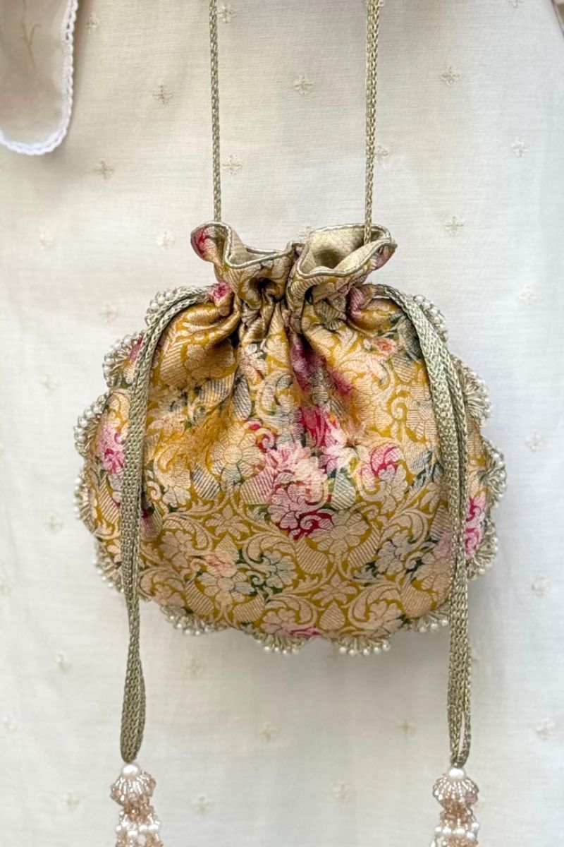 Luxury Banarasi brocade potli bag in mustard with floral embroidery and pearl embellished scalloped edges