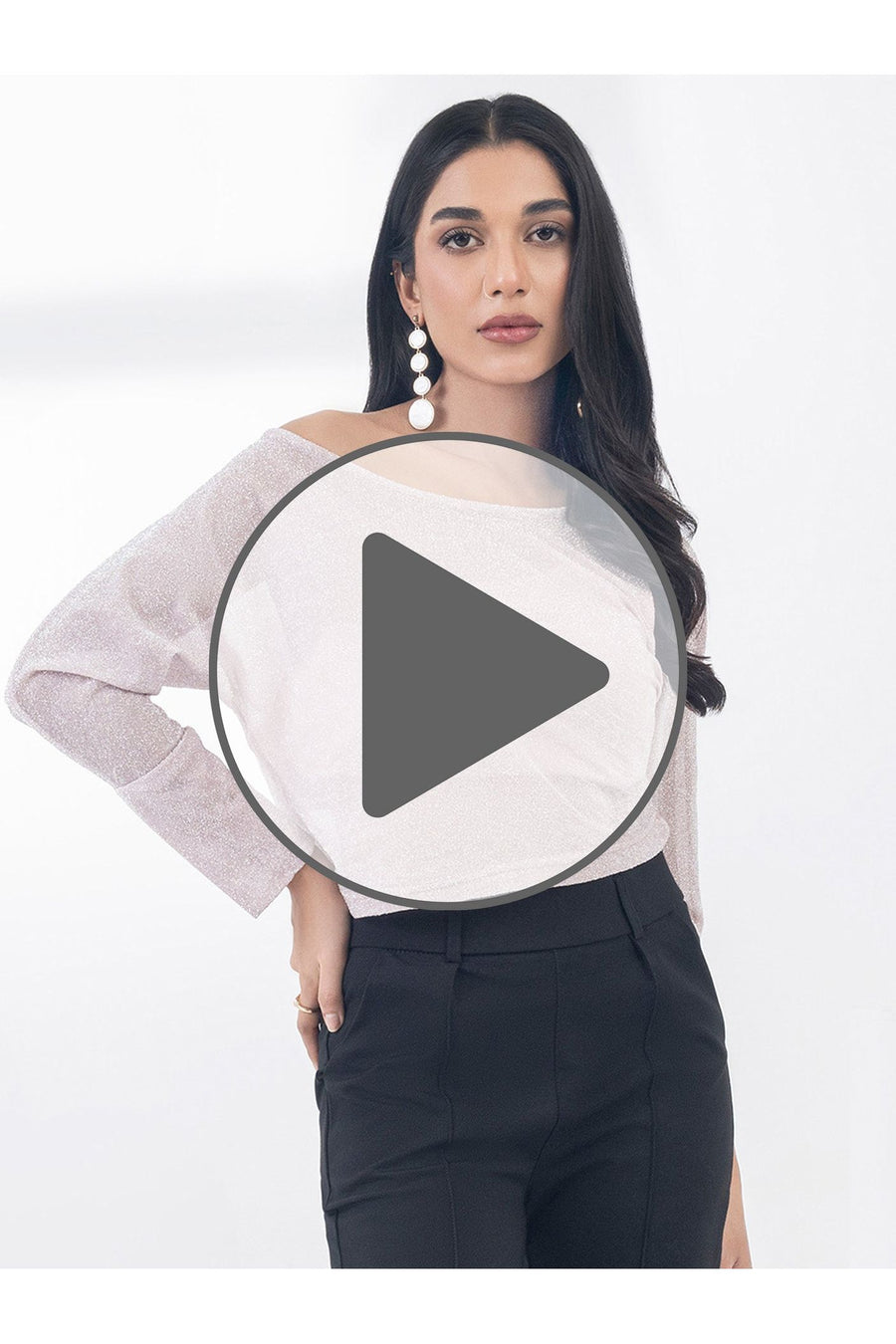 Video thumbnail of model wearing dyed jersey top with play button overlay