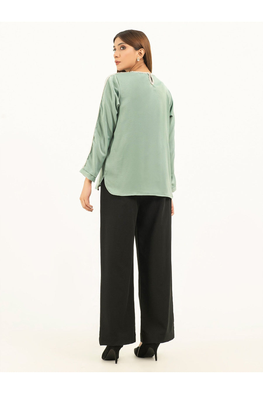 Back view of model in light green viscose top showing round hem and hooked split at neckline