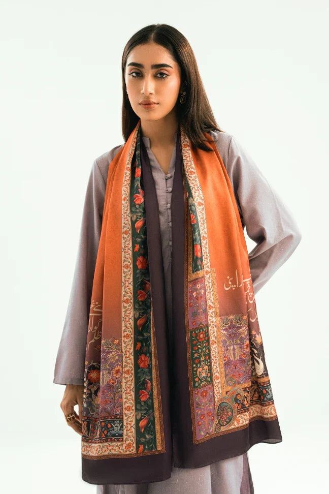 Woman wearing a luxurious embroidered silk scarf in warm orange and deep purple hues over a muted purple traditional suit.