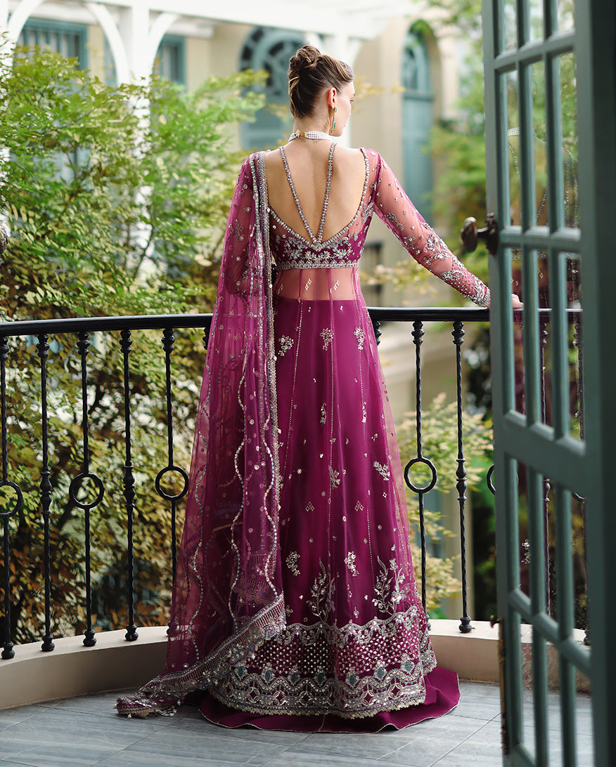 Rear view of formal magenta wedding gown featuring open back with double strap design and embroidered sheer sleeves