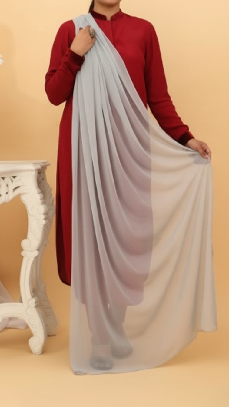 Woman wearing a maroon outfit holding a flowing grey chiffon dupatta draped elegantly