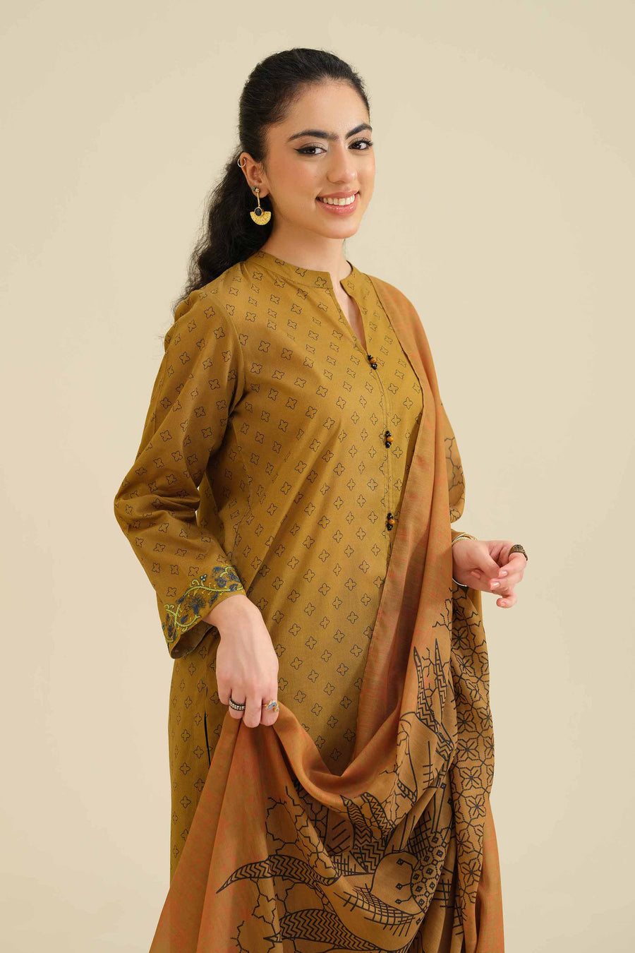 Close-up of model holding dupatta, highlighting detailed embroidery on kurta cuff