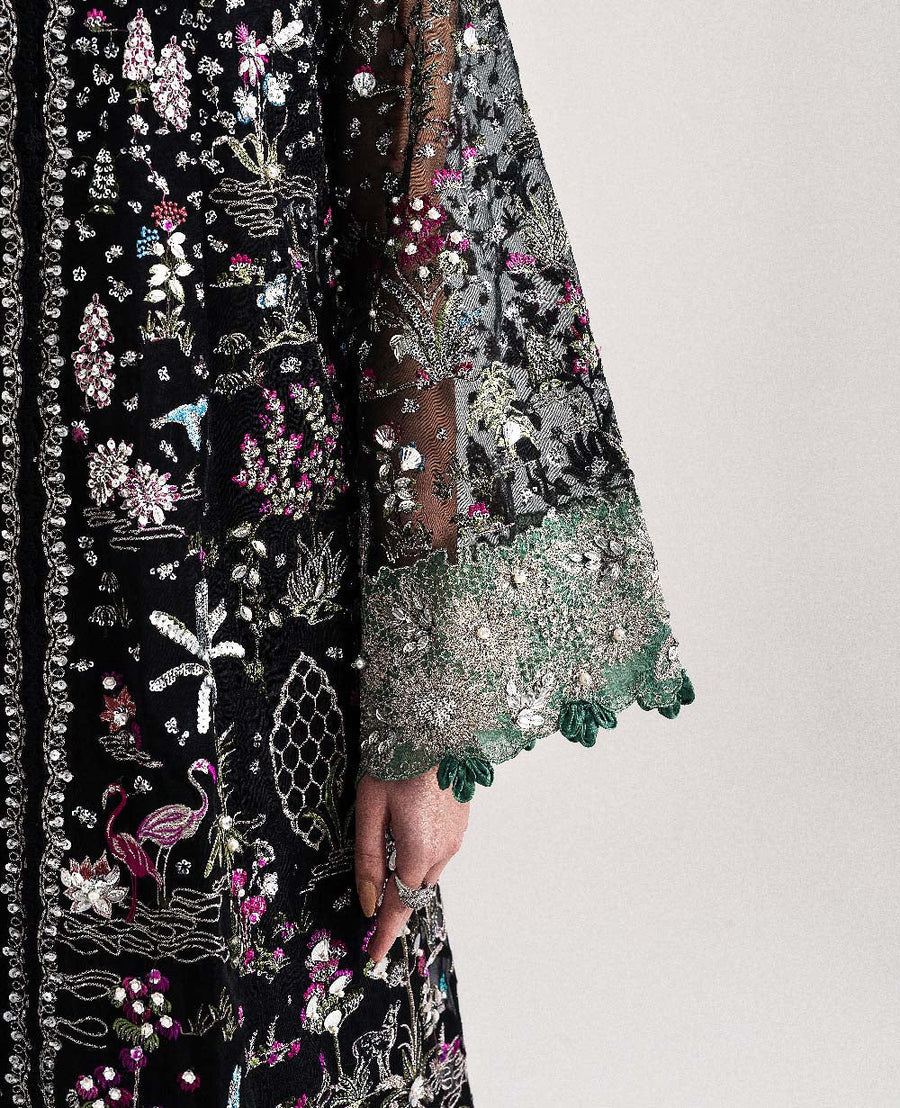 Detailed embroidery on sheer organza sleeve with green lace trim and sequin embellishments