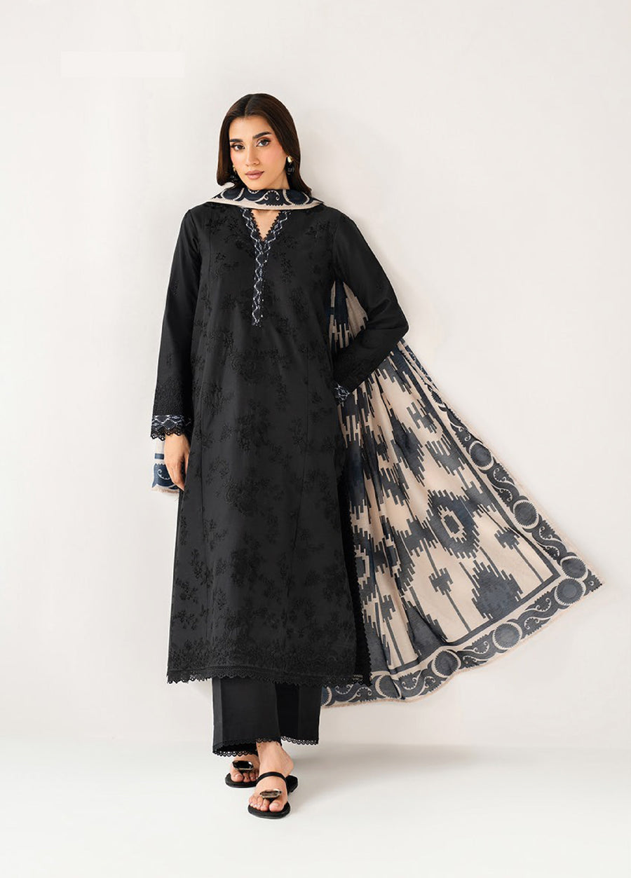 Woman wearing an elegant black embroidered long shirt with lace trim and matching pants, paired with a beige and black printed dupatta, standing against a white background.