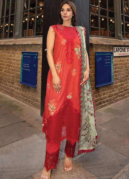 Front view of a woman wearing a red floral embroidered sleeveless lawn suit with matching embroidered trousers and a green floral chiffon dupatta.