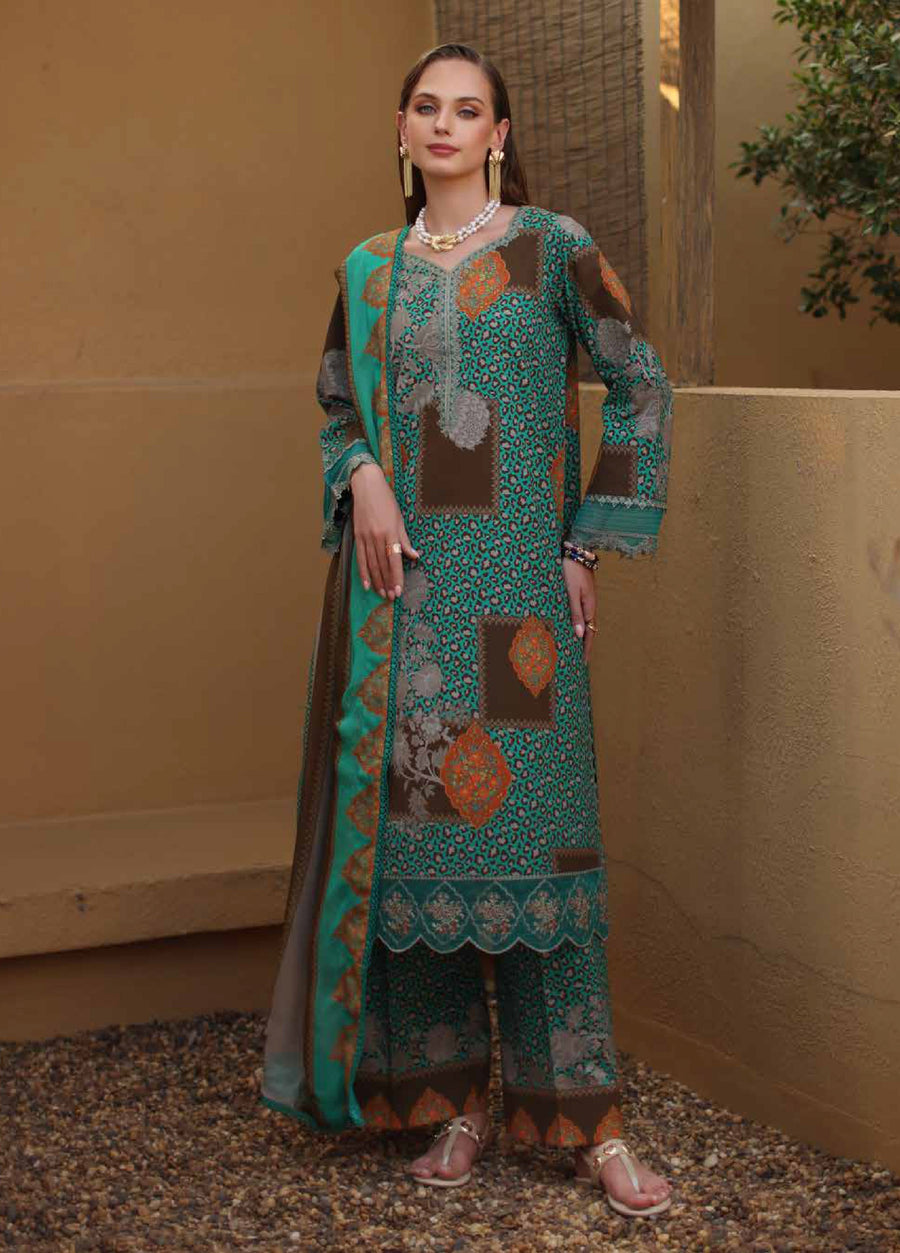 Woman standing wearing a teal, brown, and orange 3-piece embroidered lawn suit with patchwork and leopard print designs, paired with a matching dupatta and golden sandals