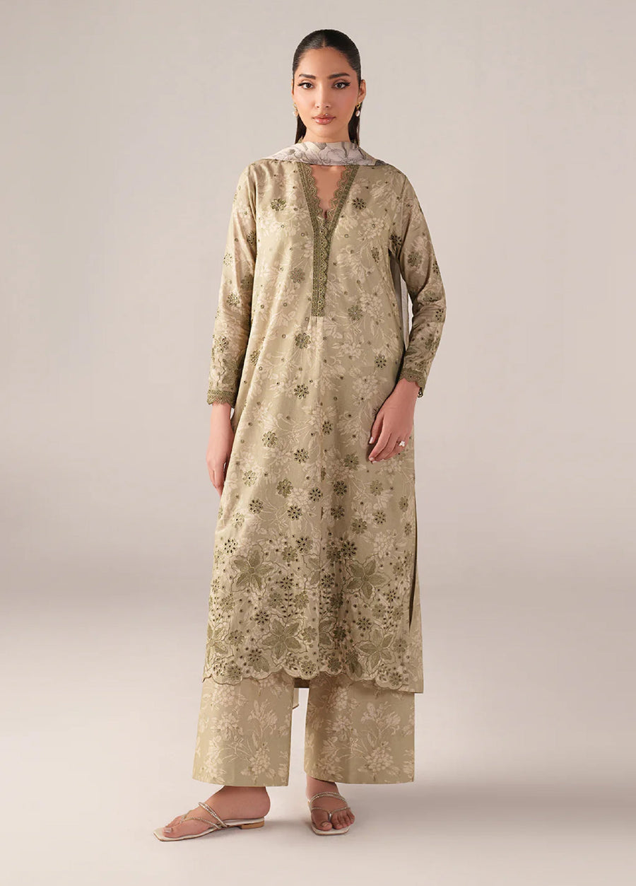 Front view of woman wearing beige embroidered lawn suit with floral patterns and scalloped hem paired with printed wide-legged trousers and floral chiffon dupatta
