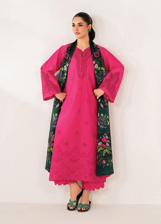Woman wearing vibrant fuchsia embroidered lawn kurta with floral eyelet patterns, wide sleeves, scalloped hem trousers, and dark green floral printed dupatta