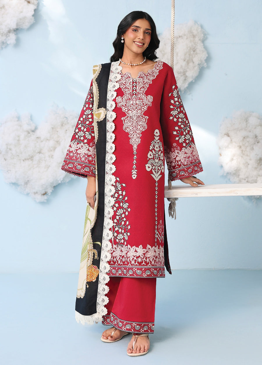 Front view of woman wearing deep red embroidered lawn suit with floral patterns and a lace-edged printed dupatta