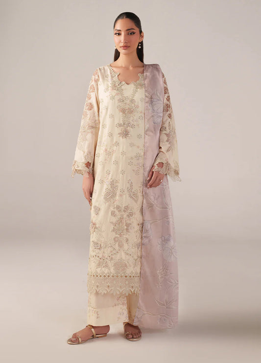 Woman wearing an elegant cream embroidered lawn suit with lace detailing and a pastel pink floral embroidered dupatta draped over shoulder