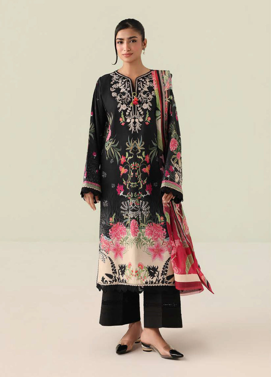 Woman wearing embroidered floral lawn suit in black with pink and green accents, paired with printed chiffon dupatta and black wide-leg trousers