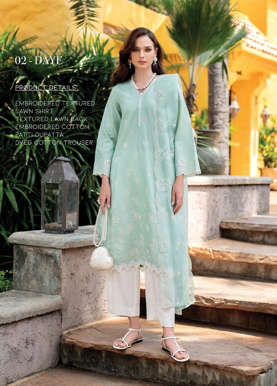 Woman wearing pastel green embroidered lawn shirt and white cotton trousers standing outdoors holding pearl heart-shaped handbag