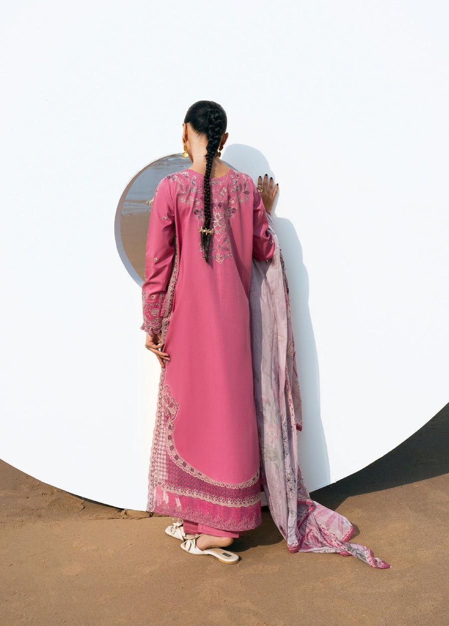 Back view of woman in pink embroidered lawn suit showing detailed embroidery on back and holding printed dupatta