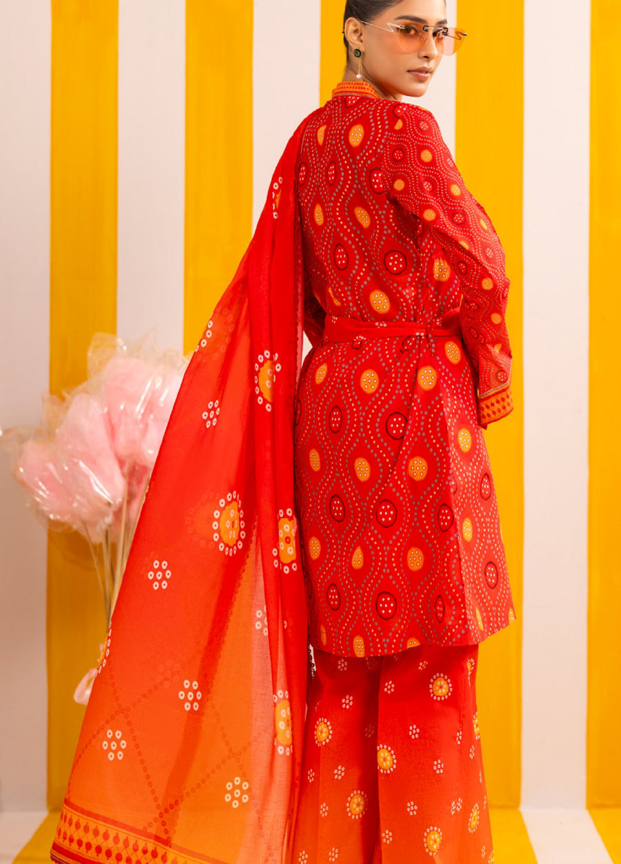 Back view of woman showcasing red printed lawn suit with wrap shirt, wide trousers, and sheer dupatta, featuring circular and dotted prints