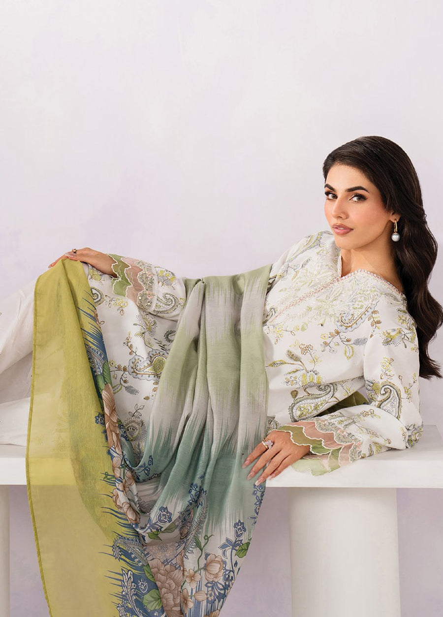 Woman reclining while elegantly displaying the floral printed chiffon dupatta, showcasing detailed embroidery on the lawn shirt sleeves and neckline.