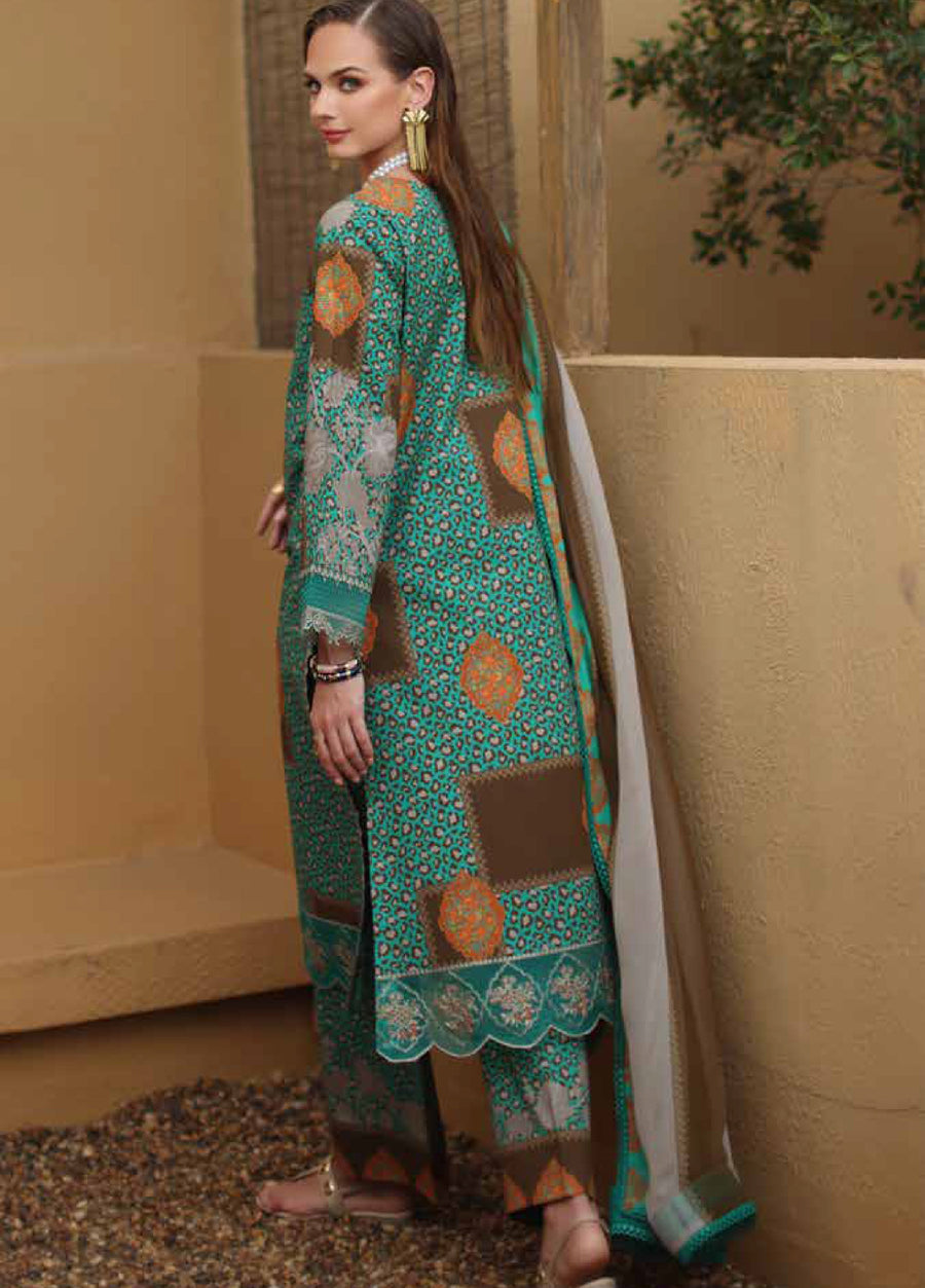 Side view of woman wearing a colorful embroidered lawn suit showing detailed embroidery on sleeves and hem paired with printed trousers and dupatta