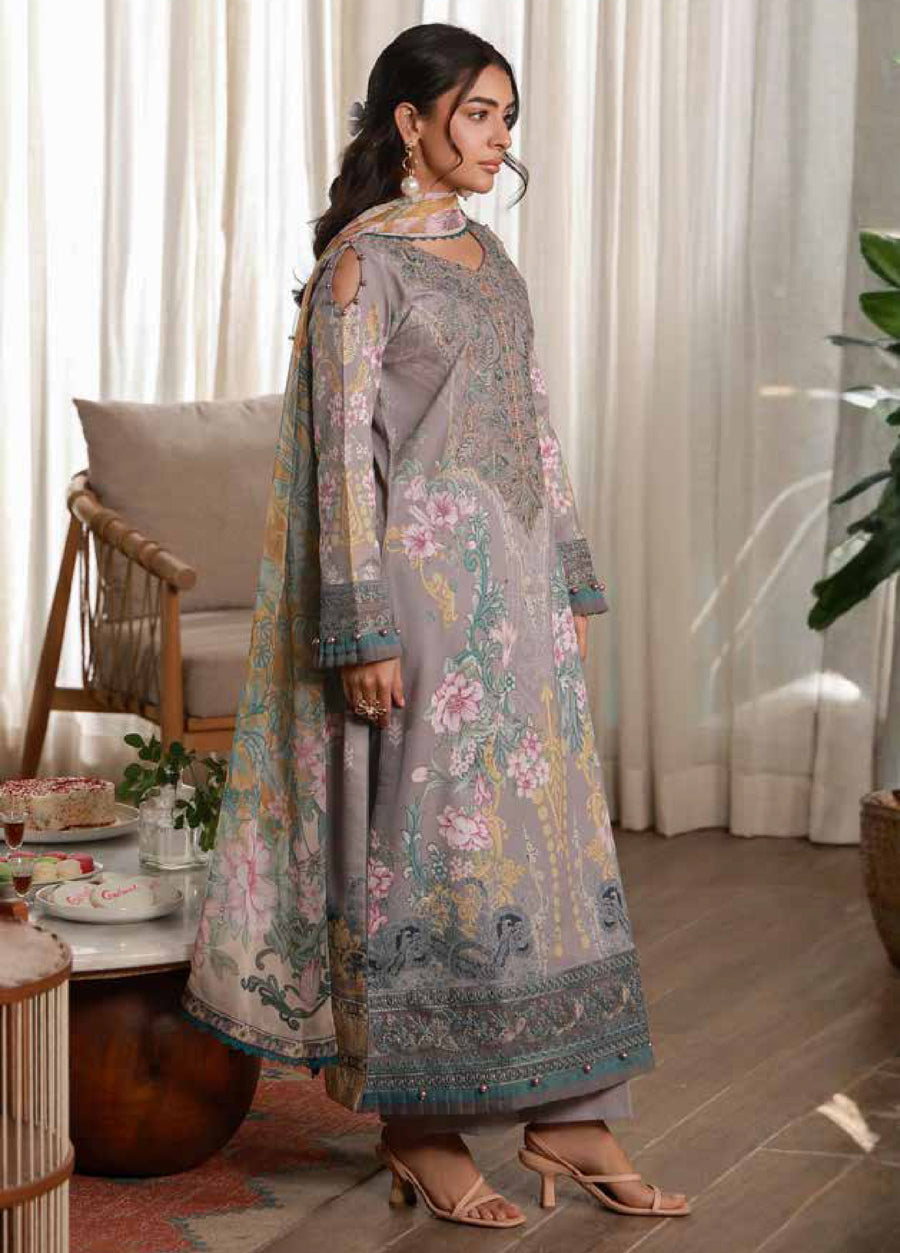 Side view of woman showcasing long embroidered lawn shirt with floral prints and matching chiffon dupatta draped over shoulder