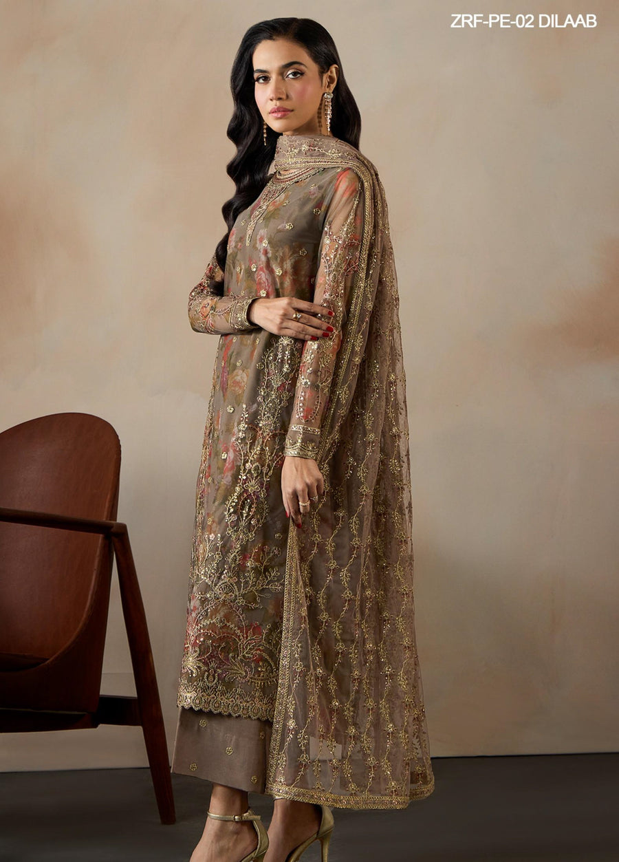 Side view of woman wearing embroidered suit showcasing detailed golden lace embroidery on sleeves and dupatta
