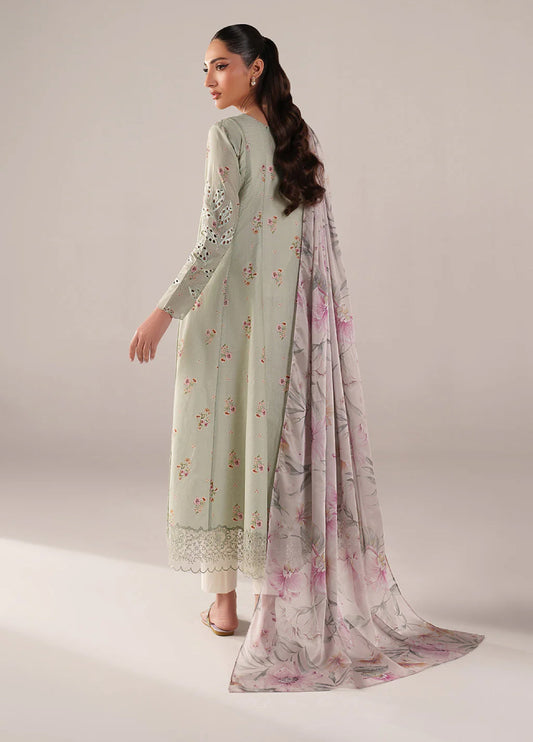 Back view of woman in embroidered green lawn frock featuring subtle floral print and airy chiffon dupatta with pink floral design