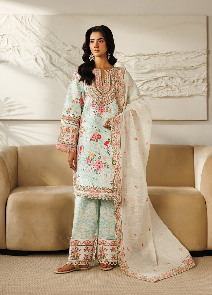 Side view of a woman wearing the pastel floral embroidered lawn suit, highlighting the detailed embroidery on the sleeves and neckline and the soft fabric drape.
