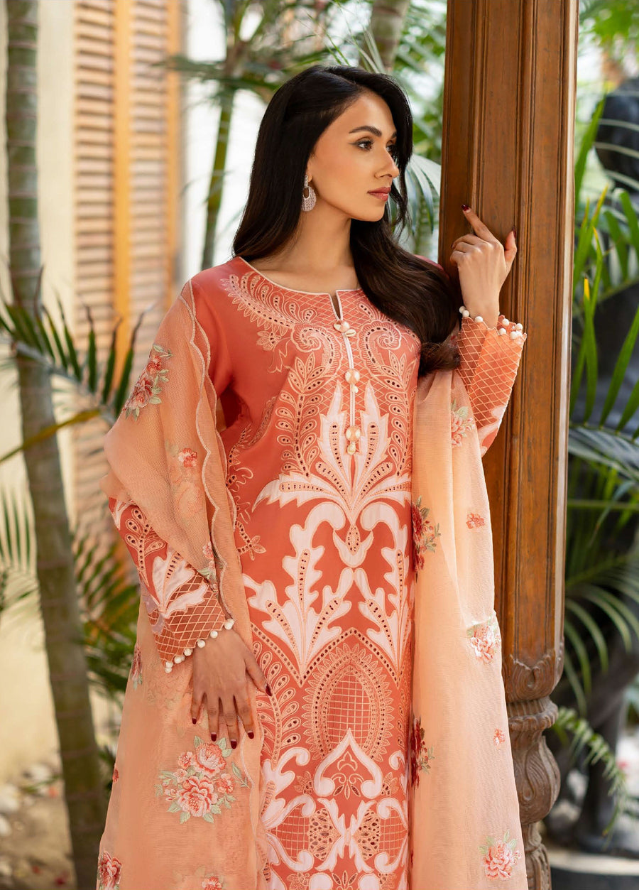 Side view of woman in embroidered peach lawn suit highlighting intricate embroidery on sleeves and peach dupatta with floral accents