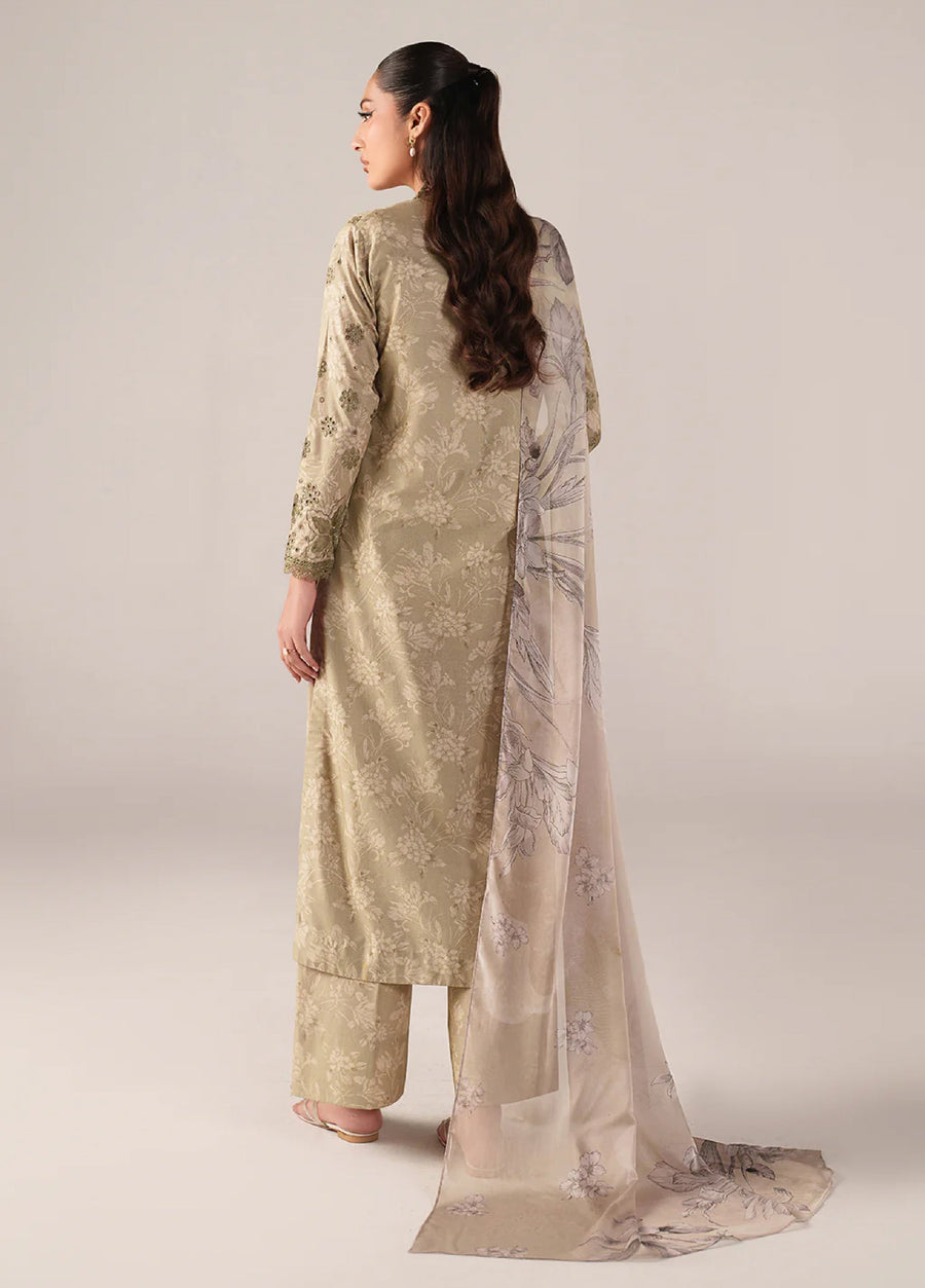 Back view of woman in beige embroidered lawn suit, displaying the smooth fabric work, floral chiffon dupatta flowing behind, and embroidered sleeve details