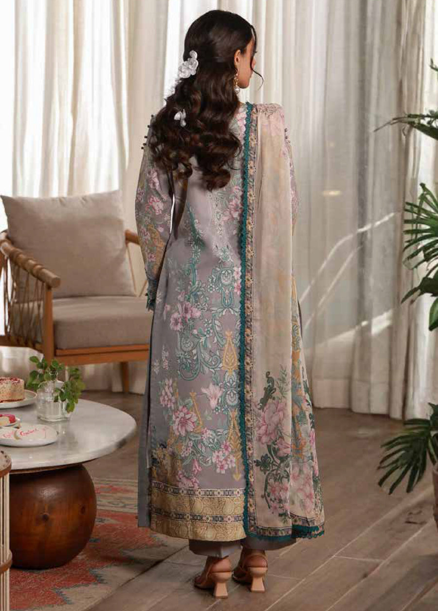 Back view of woman wearing embroidered lawn suit highlighting detailed print on shirt and flowing chiffon dupatta softly hanging