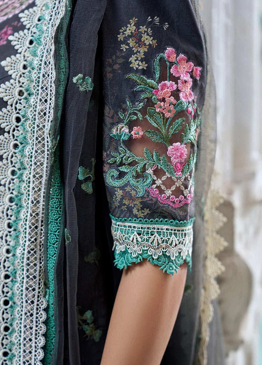Close-up of lawn suit sleeve featuring intricate pink and green floral embroidery on net fabric with lace borders.