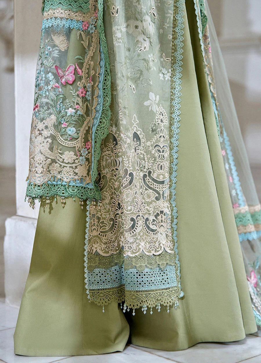 Detailed view of the embroidered net dupatta hanging over the wide-leg green trousers, showcasing intricate lace edges and bead tassel finishing