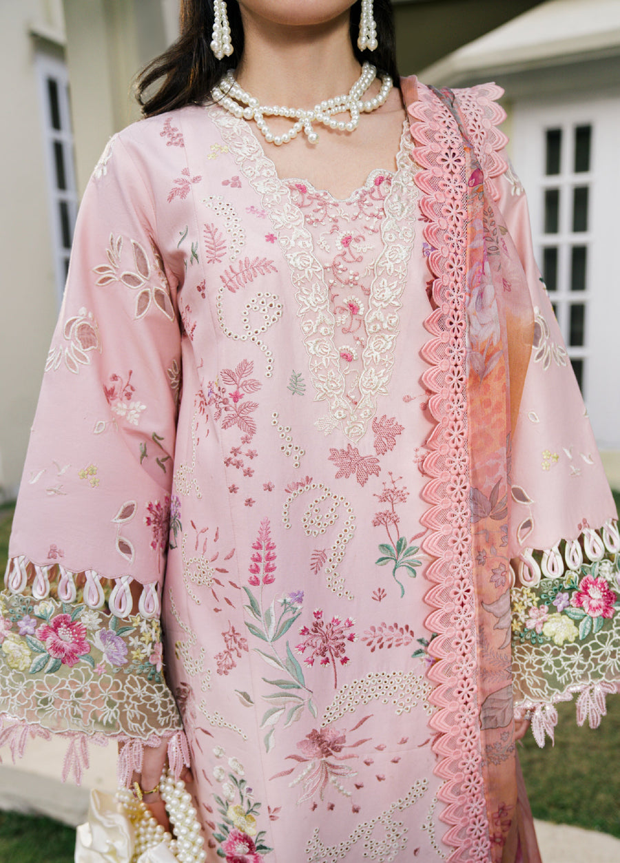 Detailed close-up of embroidered floral patterns and lace trimming on the sleeve and front of the baby pink luxury lawn suit.