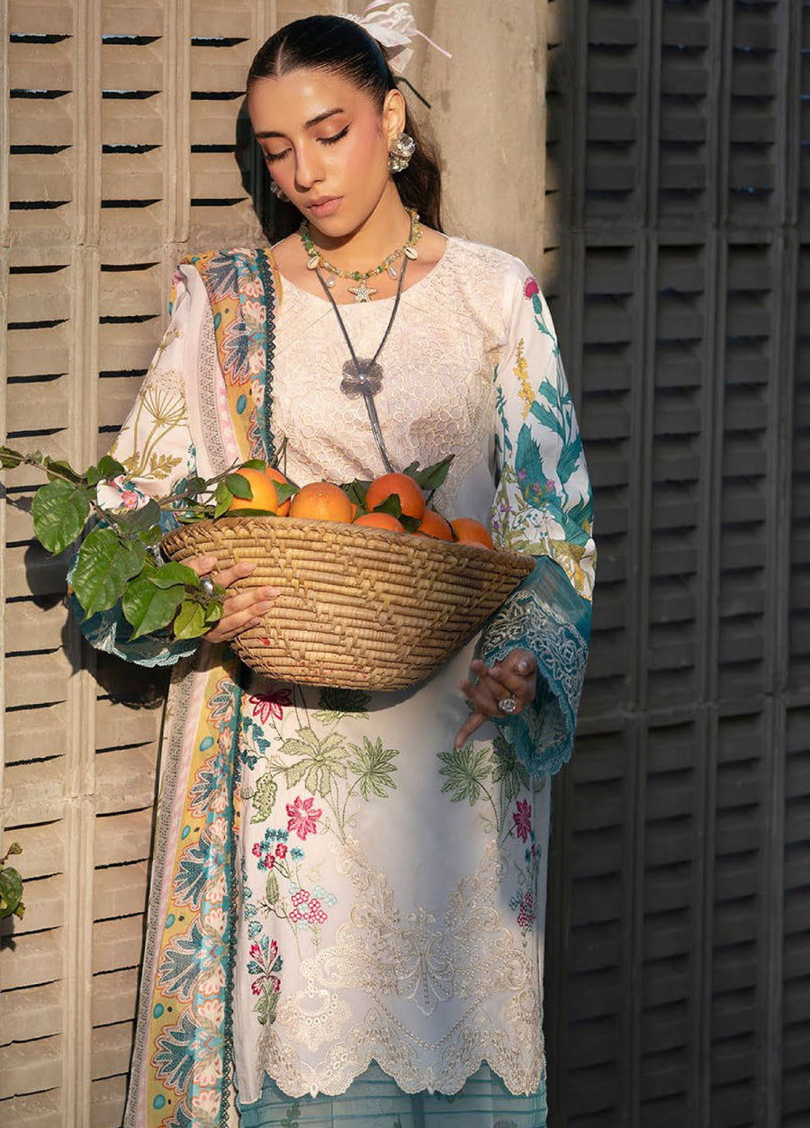 Woman holding a woven basket filled with oranges wearing white and teal embroidered 3-piece lawn suit with floral designs and lace trims, soft sunlight on her face.