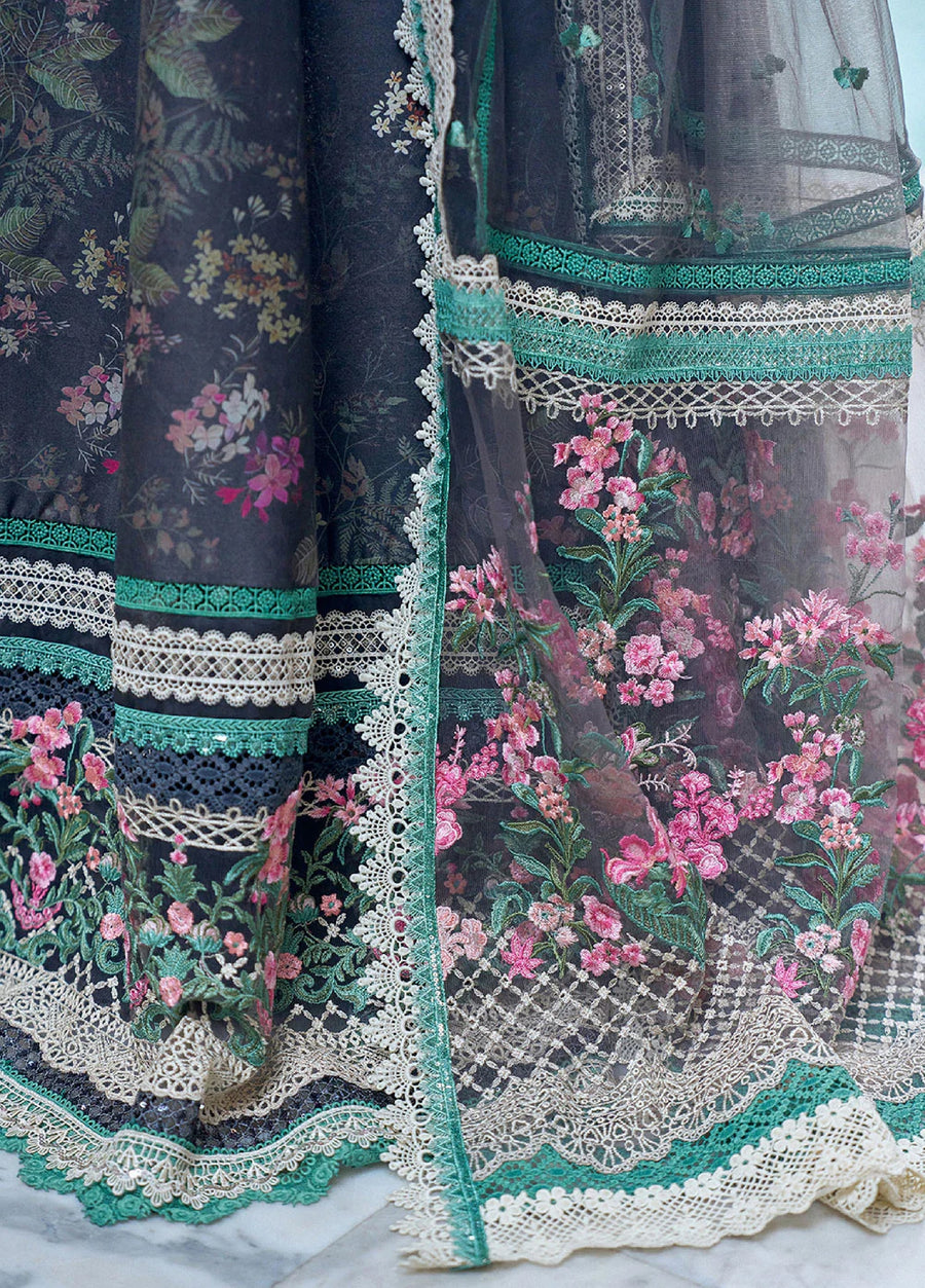 Detailed close-up of the net dupatta hem showcasing elaborate floral embroidery in pink and green with lace edging and layered borders.