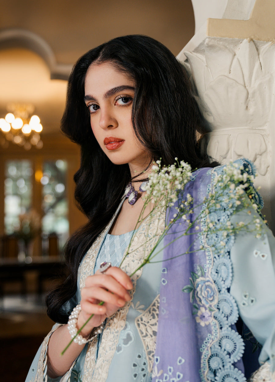 Detailed view of intricate lace neckline and floral embroidery on ice blue lawn fabric with lavender dupatta